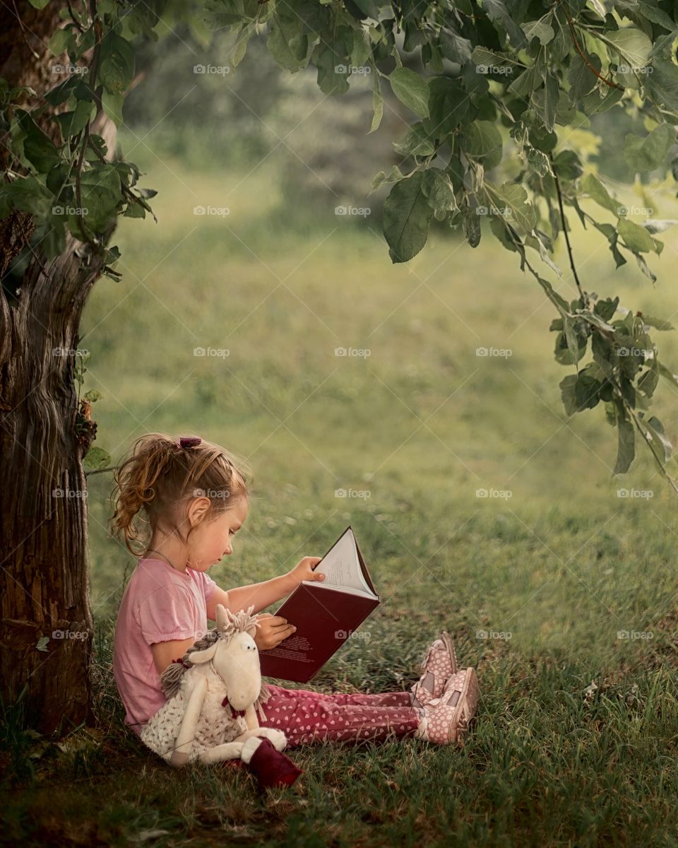 Girl reading the book outdoor