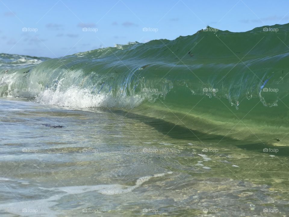 Up close photo of a small wave crashing in Deerfield Beach. 