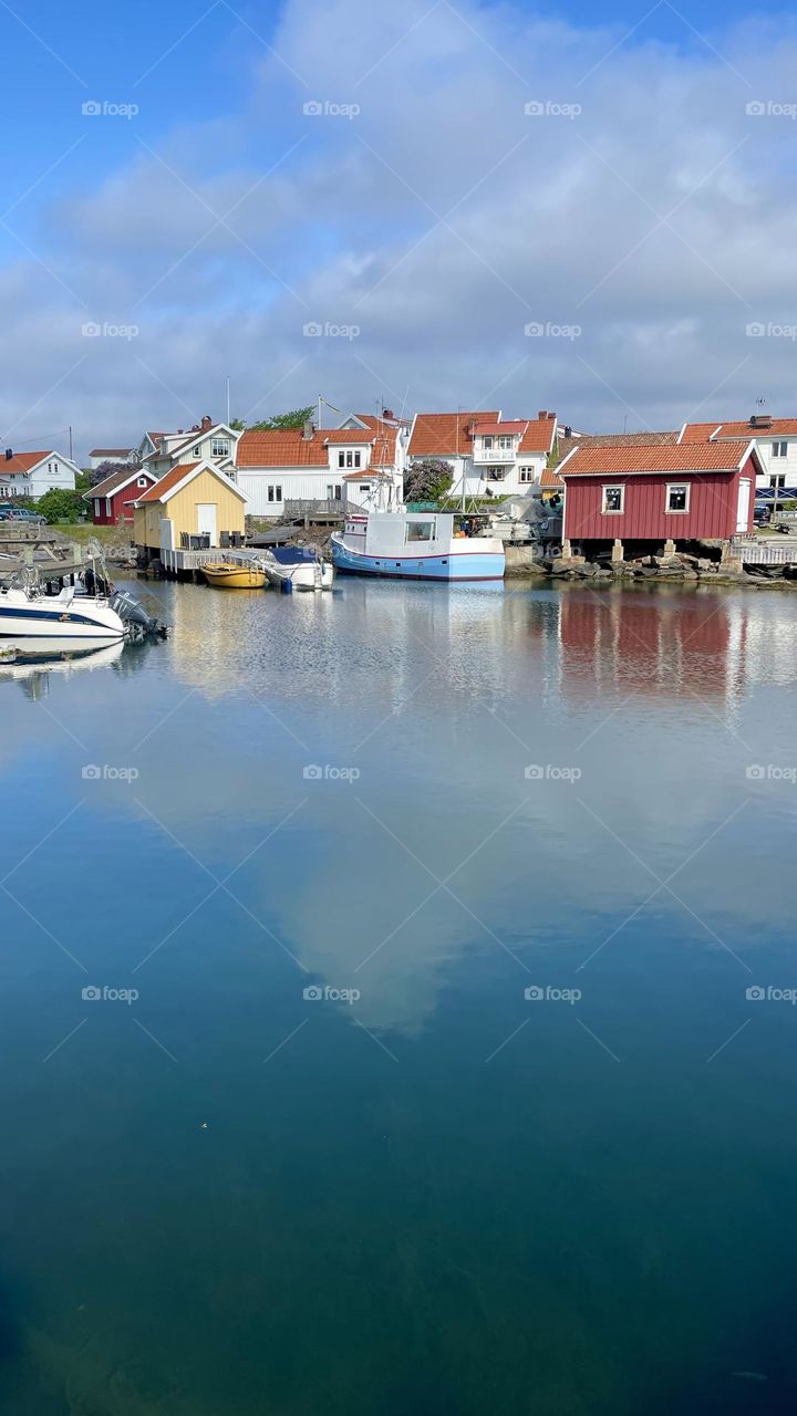 Small beautiful old little fishing village by the ocean on the Swedish west coast Bohuslan on a sunny day 