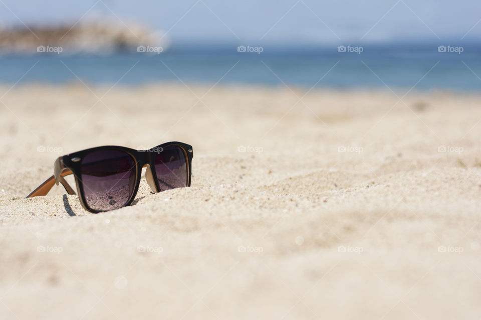 sunglasses in the sand. sunglasses on a sandy beach