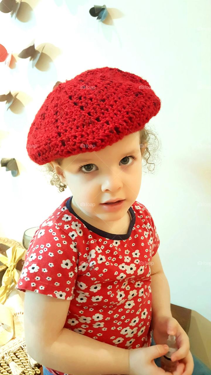 hand-made red hat using crotchet