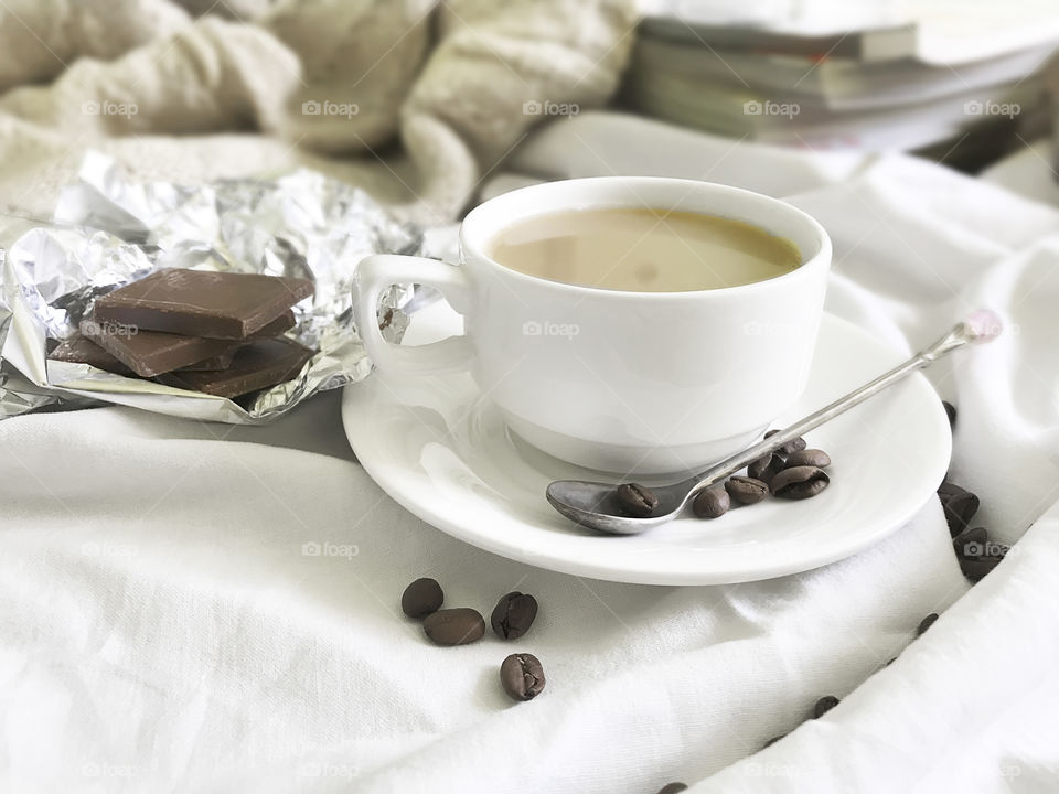 Coffee and chocolate in cozy bed 