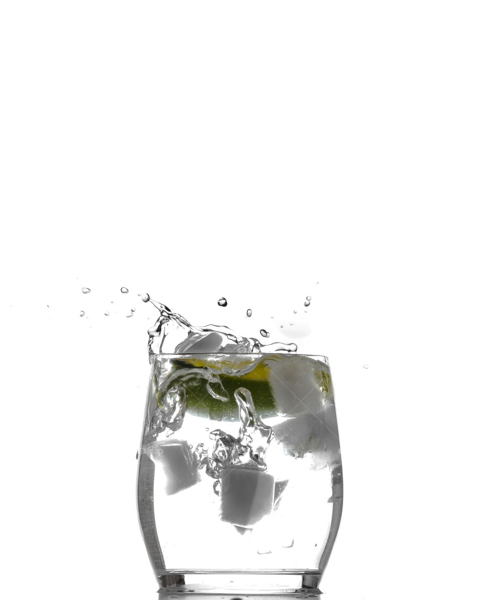 Drop of lemon over ice and water