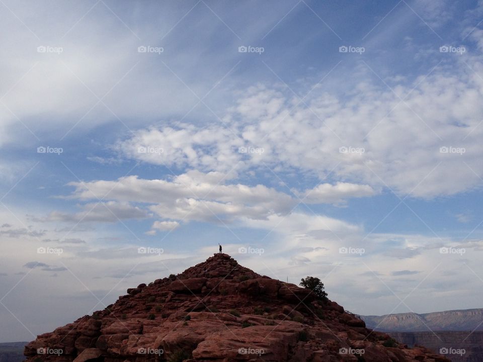 Joyous hiker on hilltop. Hiker happy to be on top of a hill