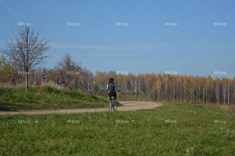 person riding on a bike autumn landscape