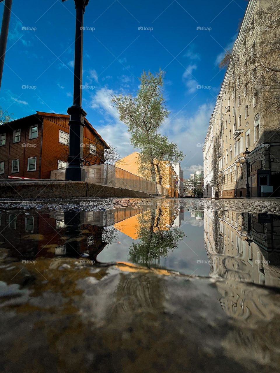 Moscow street and puddle reflection 