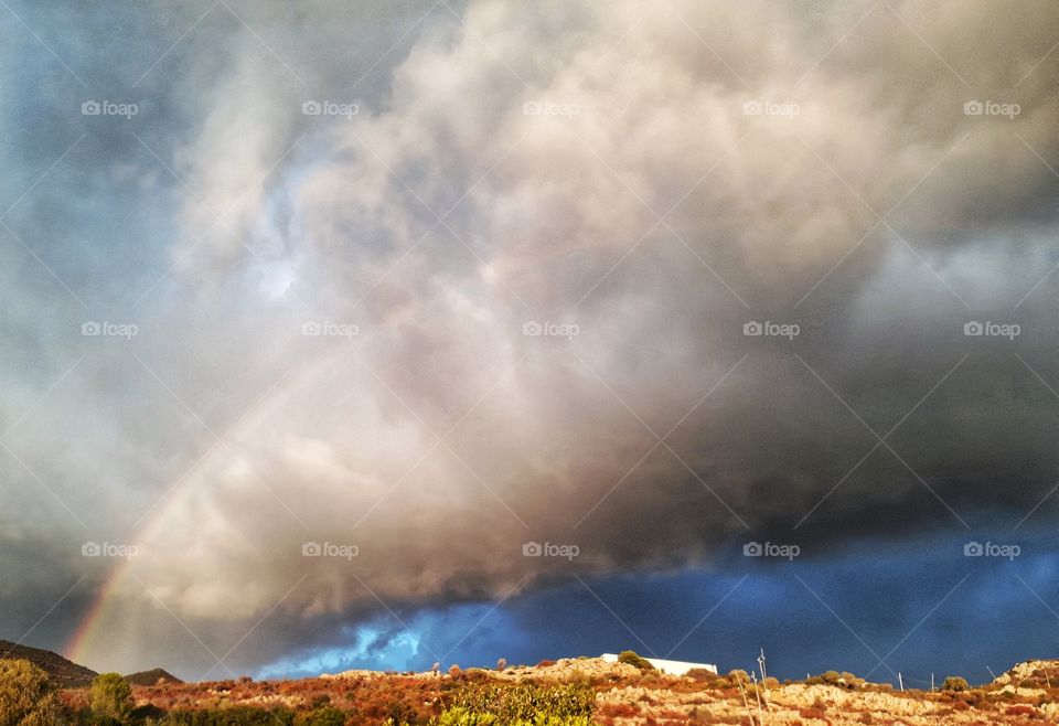 rainbow in the black clouds