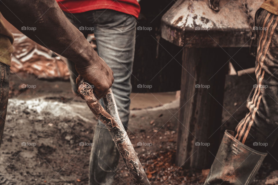Selective focus of a man holding a shovel  a shovel with the hand 
