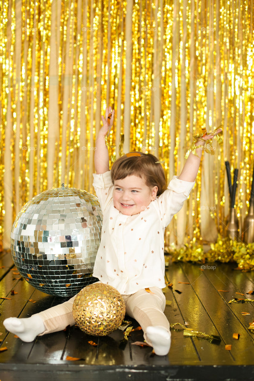 Little girl playing with disco balls