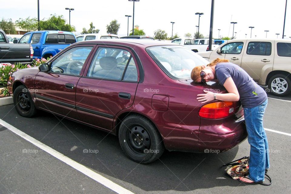 Girl saying goodbye to her car