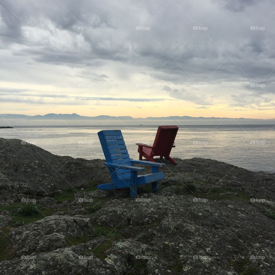 Chairs on the shore of Gonzales Beach, Victoria, British Columbia, Canada. 