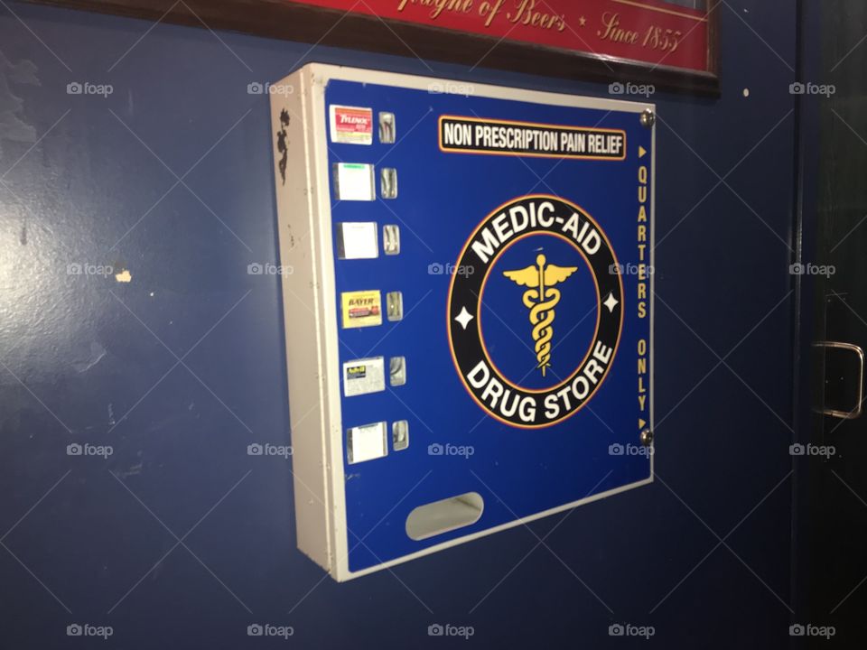An old fashioned medicine dispenser at a bar, packs sold by the quarter.