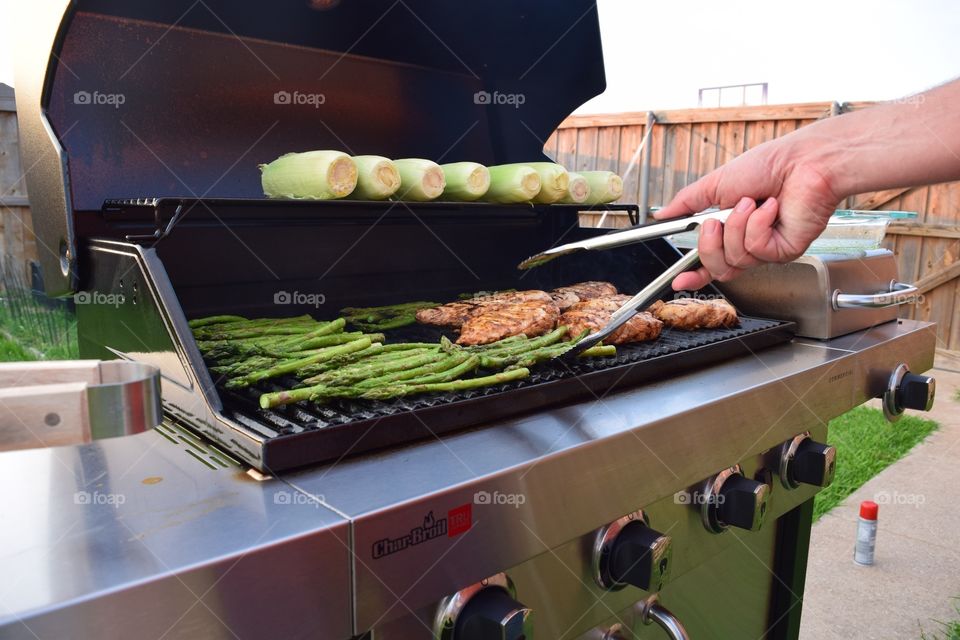 Chicken on the grill. Grilling chicken, corn and asparagus 