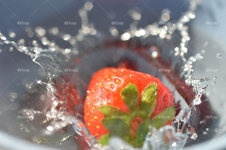 splash of strawberry into water macro