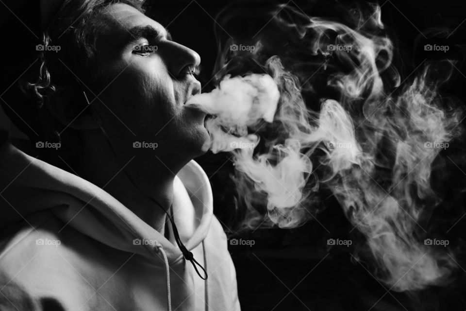 Close-up of a man with smoke