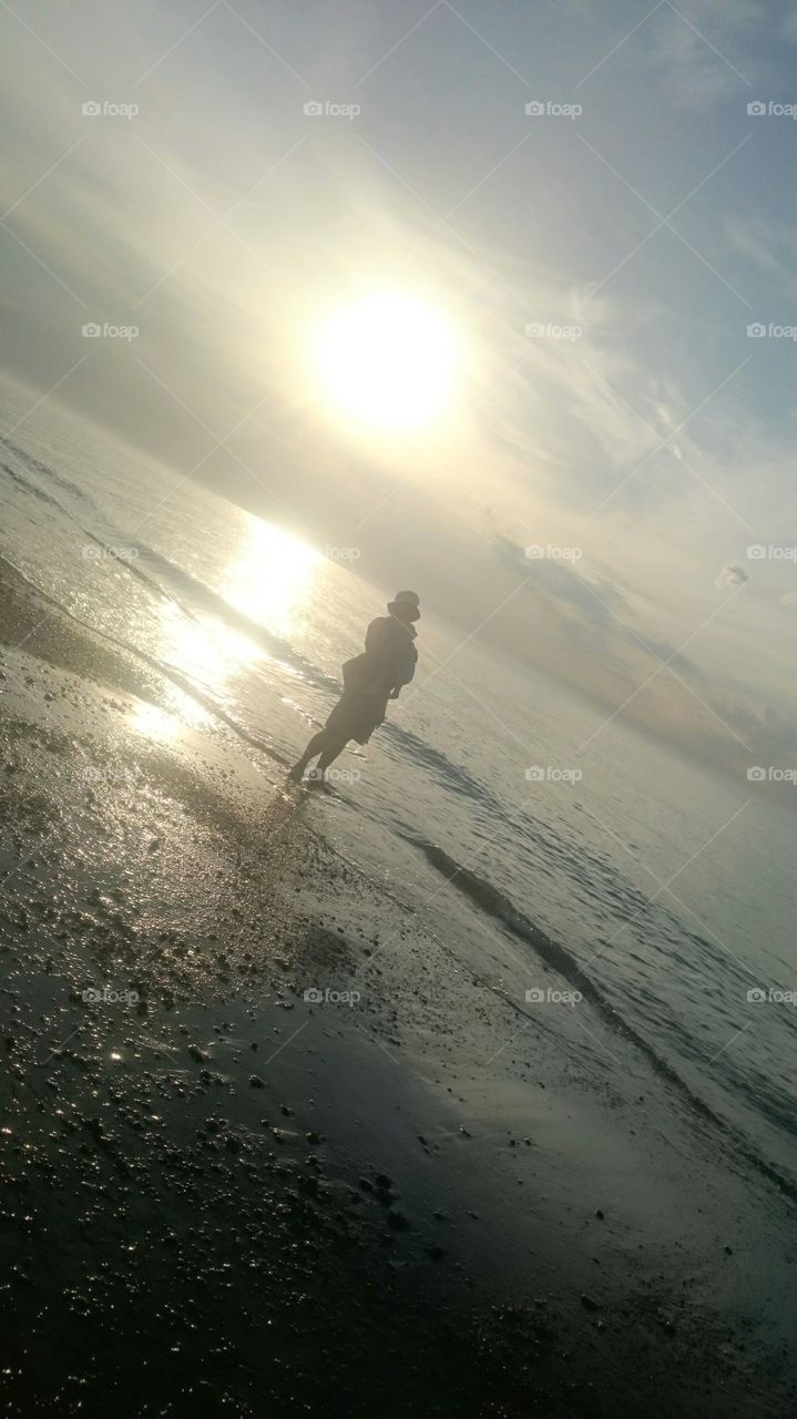 baby wearing at sea sunset. Poland