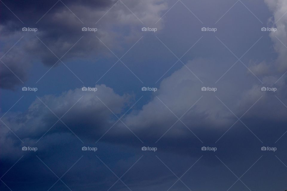 Threatening Clouds - storm clouds gathering against a dark sky