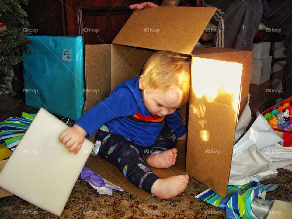 Boy Playing In A Cardboard Box
