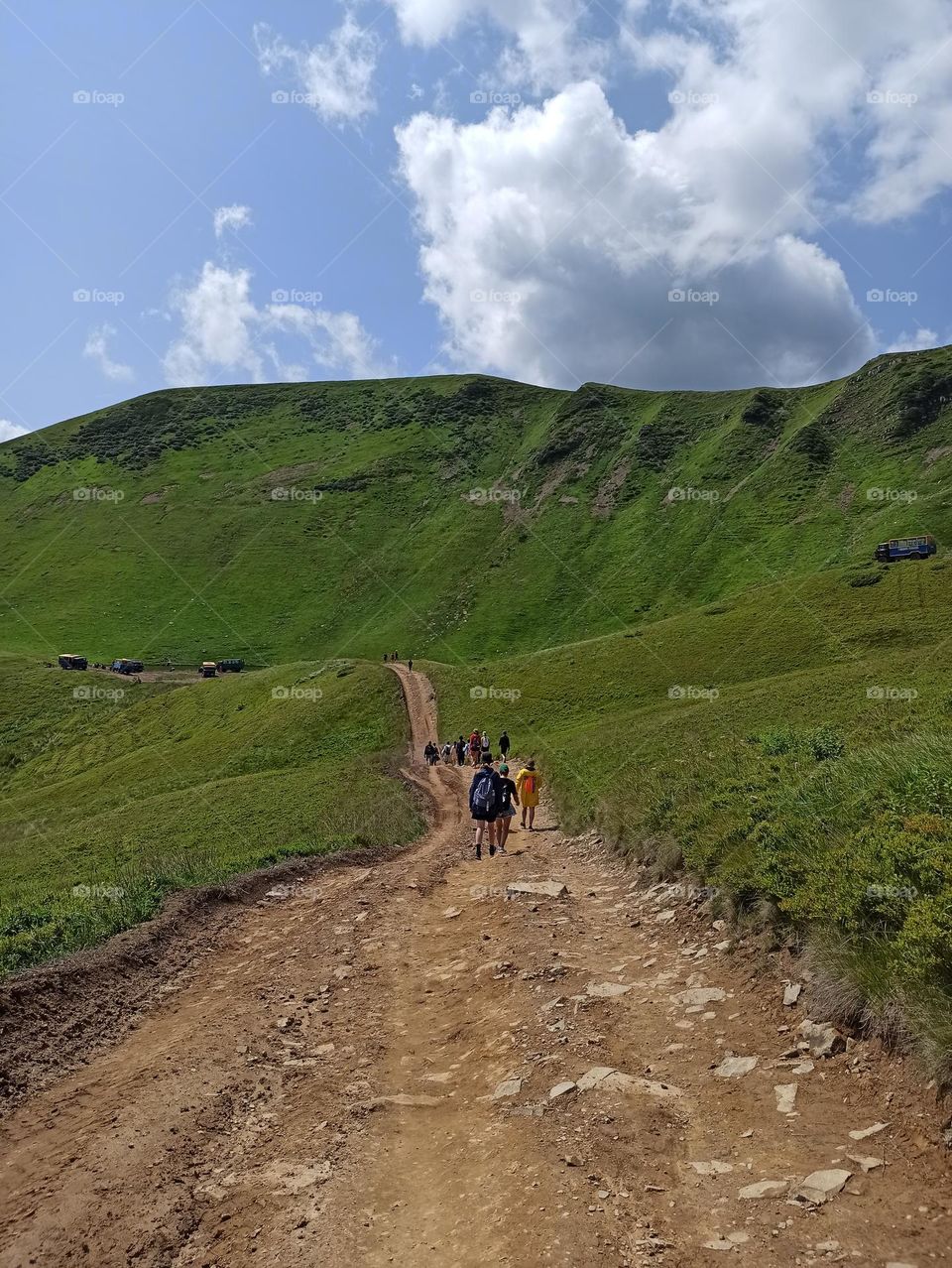 mountain road, road to the lake in the mountains, people walk along a winding road in the mountains. Dragobrat. Lake Hereshaska, Ukraine, Carpathians, meadow, valley in the mountains, summer, travel, journey, tourism, tour, adventure, interesting lif