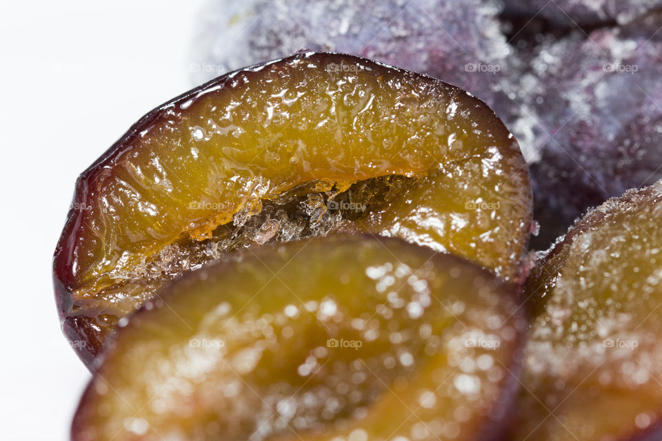 frozen slices of plum,  close up.  freezing fruits concept