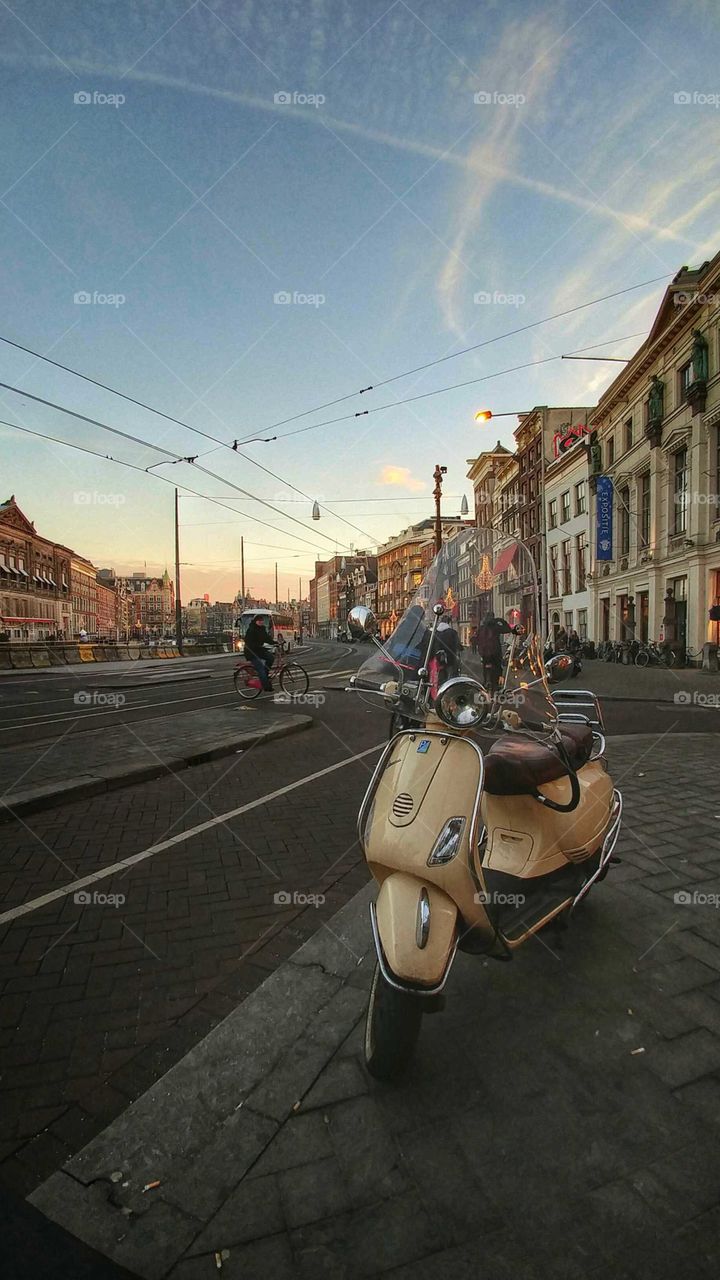 street with scooter, bicycle and tram