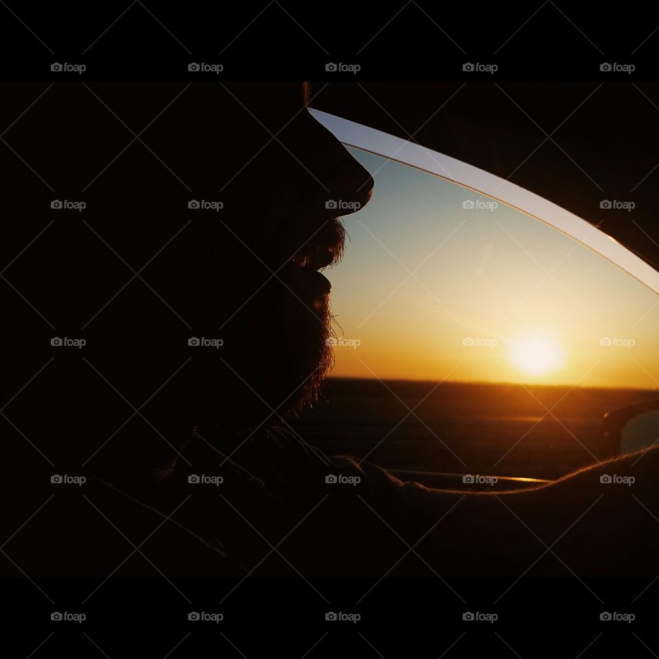 sunrise. driving on a lonely road, silhouette of a man in the sunrise