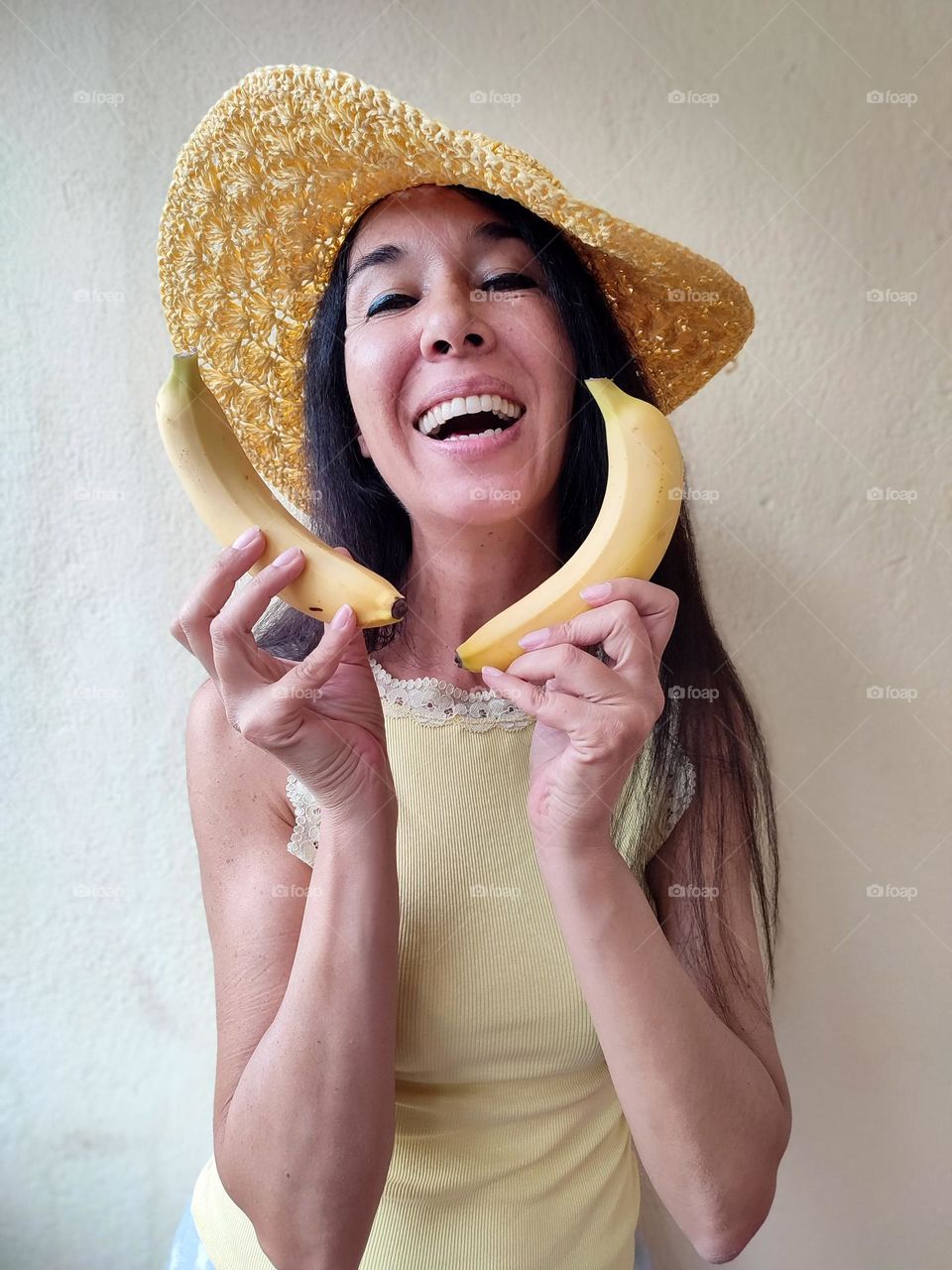 Funny Portrait of Beautiful Smiling Woman with bananas