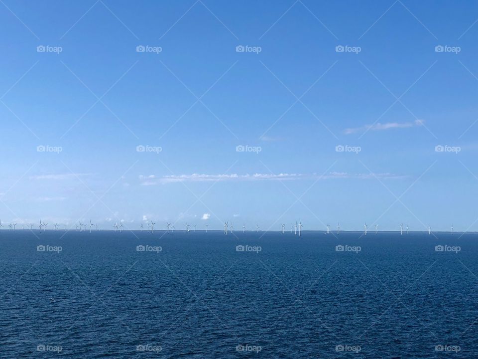 Aeolic power towers in the middle of Baltic Sea on a sunny day