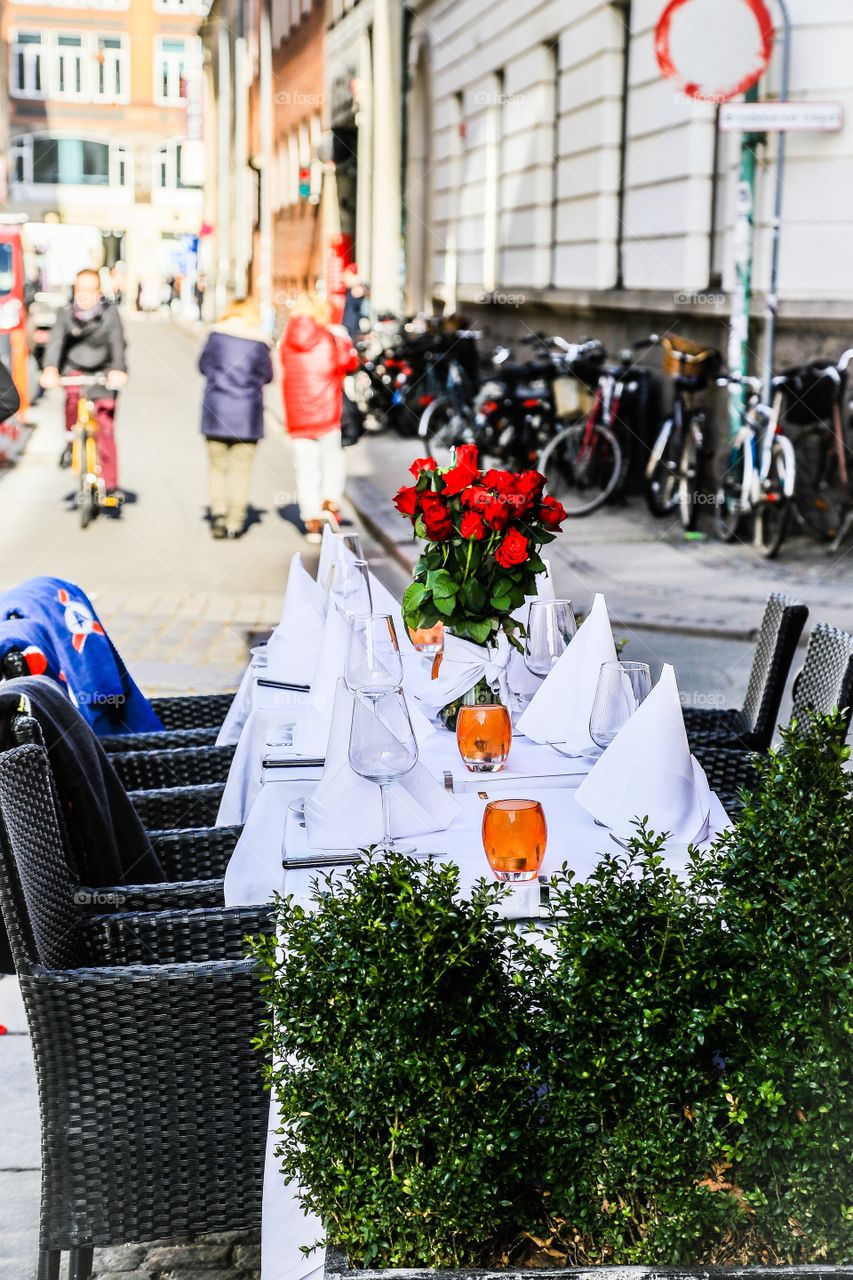 Table all set for a nice dinner outsider. Table set for a nice dinner outside on the street on a sunny day 