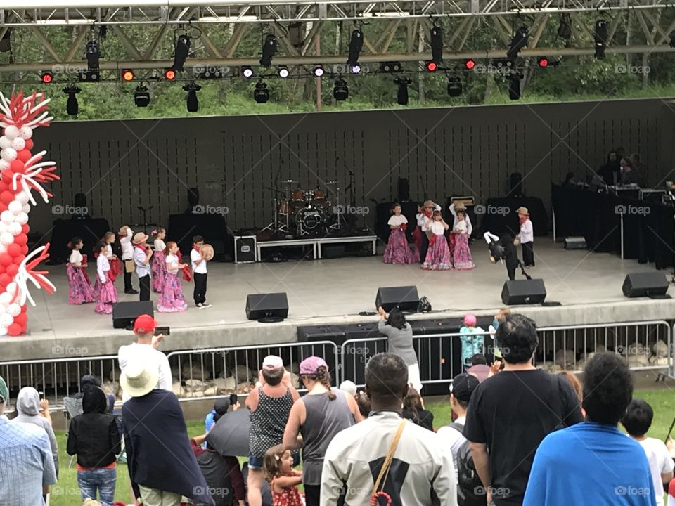 Kids dance on stage for Canada Day at Bower Ponds.
