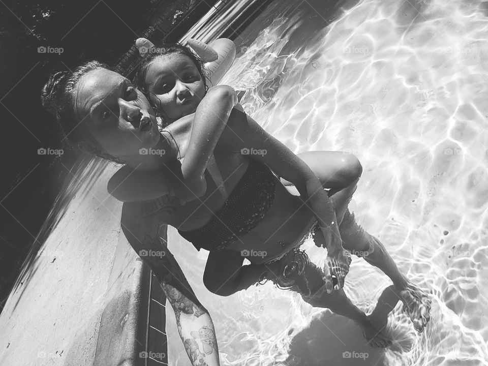 Mother and daughter in pool 