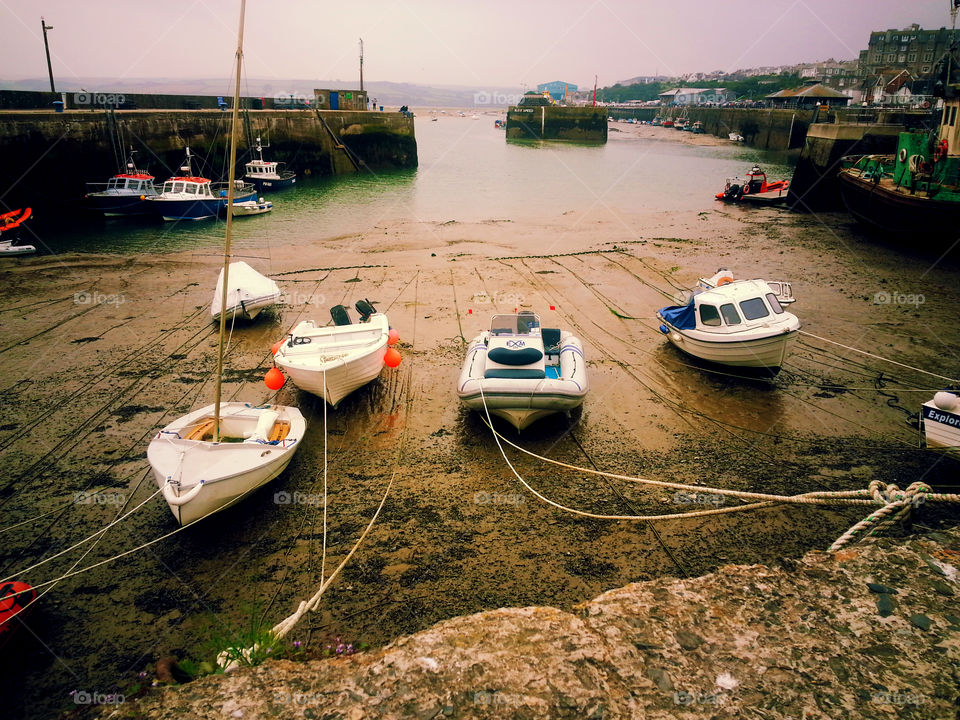 Boats during tide. Boats on dry land during tide in Cornwall UK