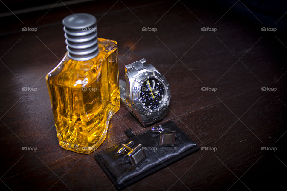 Aftershave with watch and cuflinks ready on wedding dag