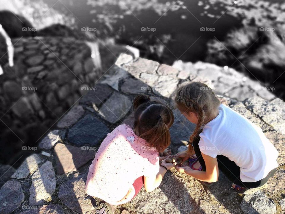 girls playing with stones