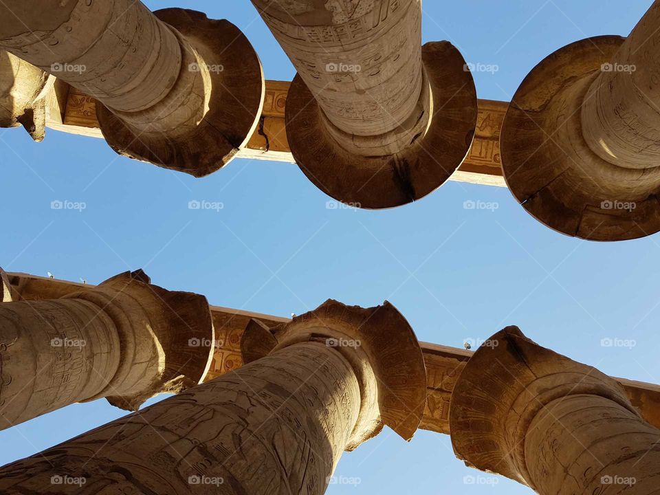 ancient egyptian karnak temple hundreds of columns hall. top of columns of temple