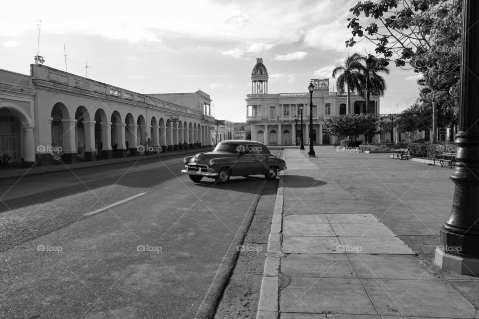 Cienfuegos, Cuba - 22 December 2013: Monochrome photo of a classic American car on parking lot in downtown Cienfuegos, Cuba on a sunny evening.
