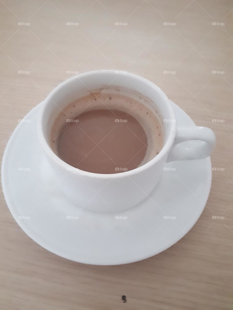 a cup of delicious cappuccino latte coffee served on a wooden table in the morning