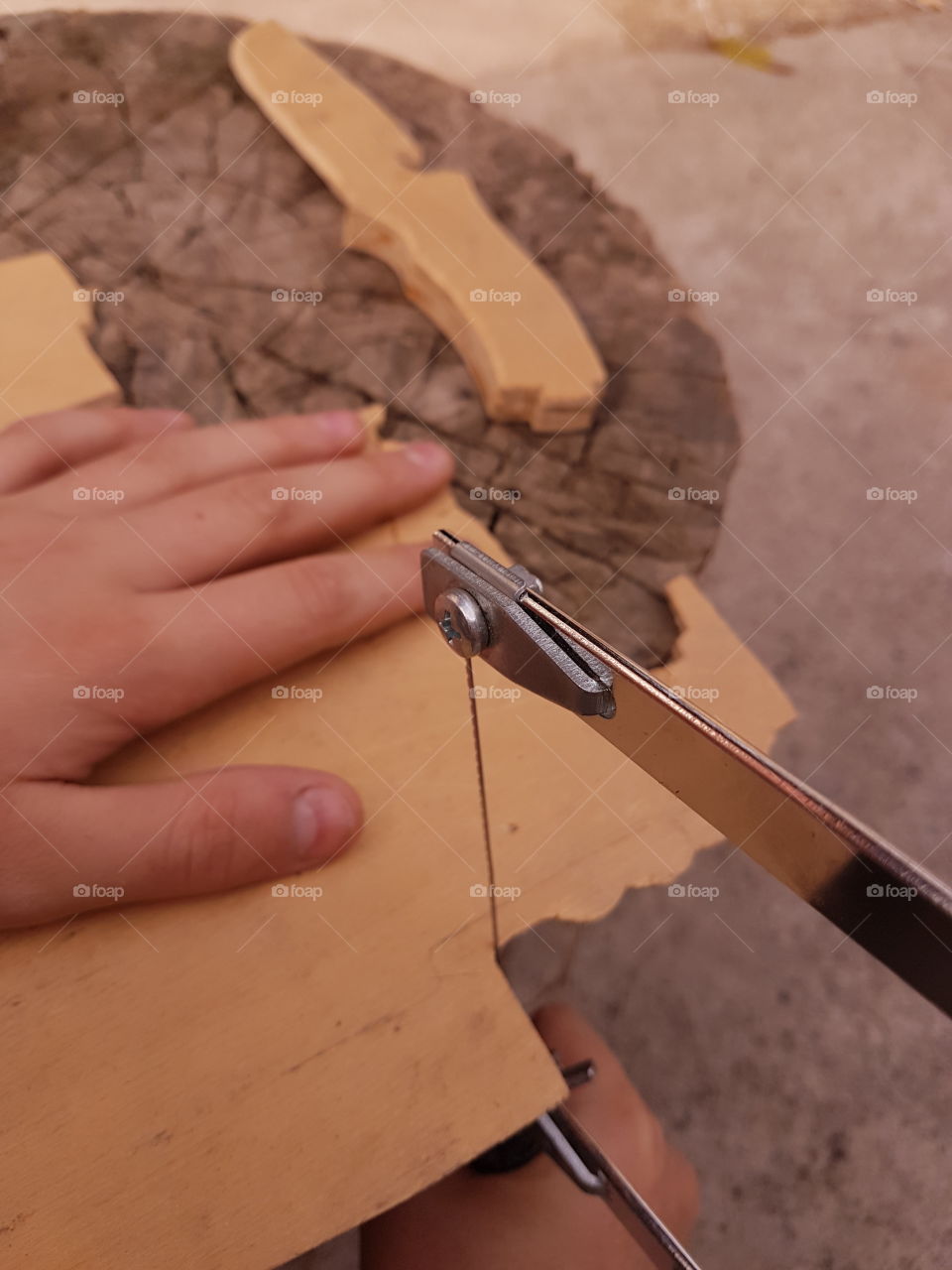 sawing a piece of wooden plywood with a jig saw