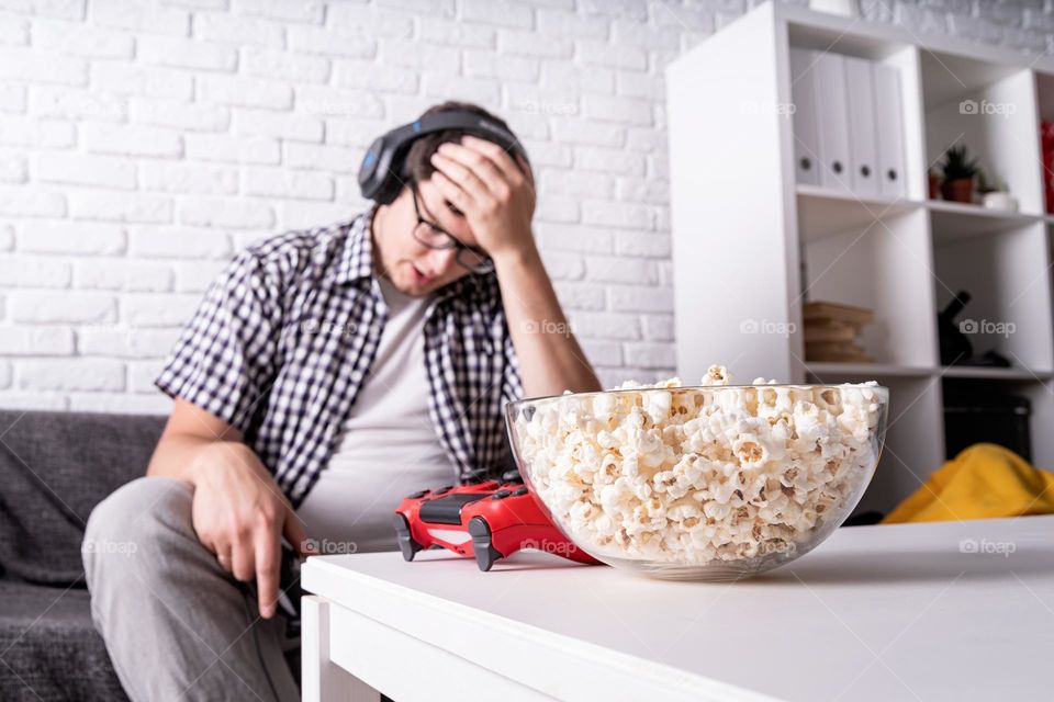 young emotional man playing video games