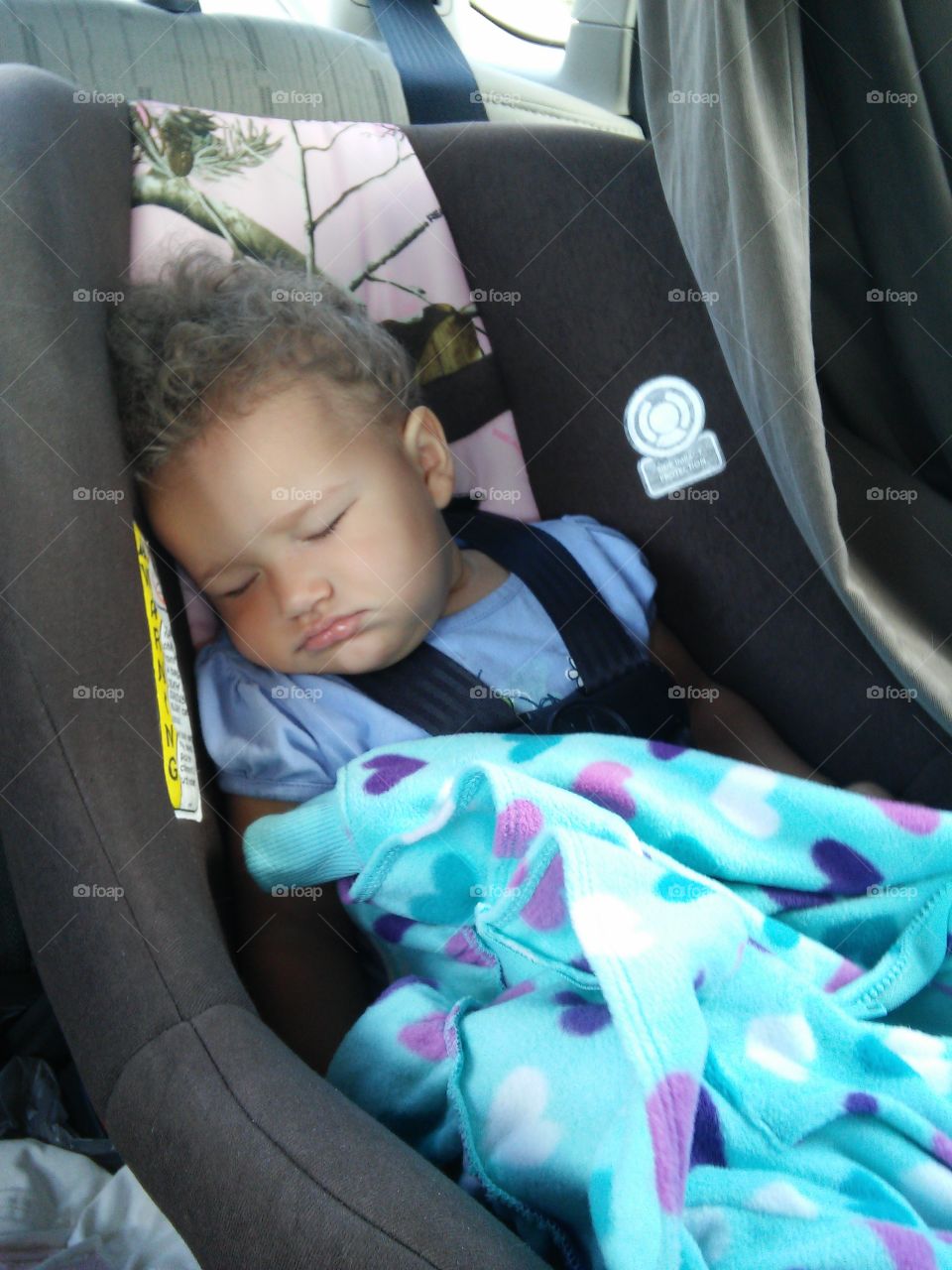 Tired baby sleeping. After a long day at the beach, 10 month old Tia fell asleep instantly on the drive home!!