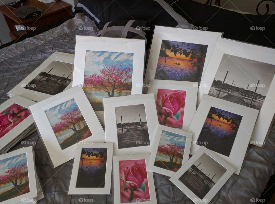 Matted photo prints scattered in varying sizes