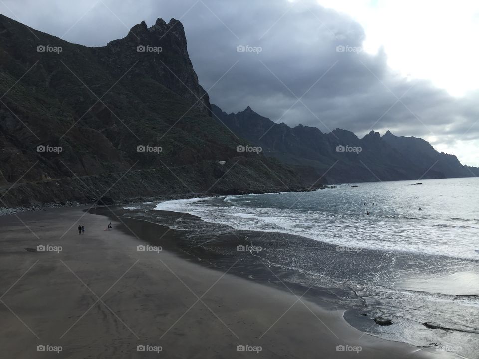 A beach in teneriffe. A cloudy day. The beach is empty.