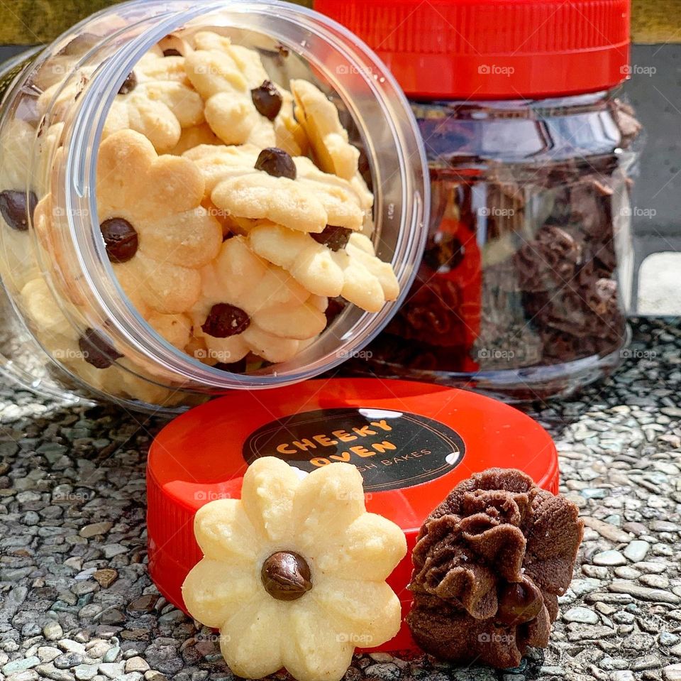 Dark chocolate chips cookies and almond butter cookies in a green nature background , freshly baked 