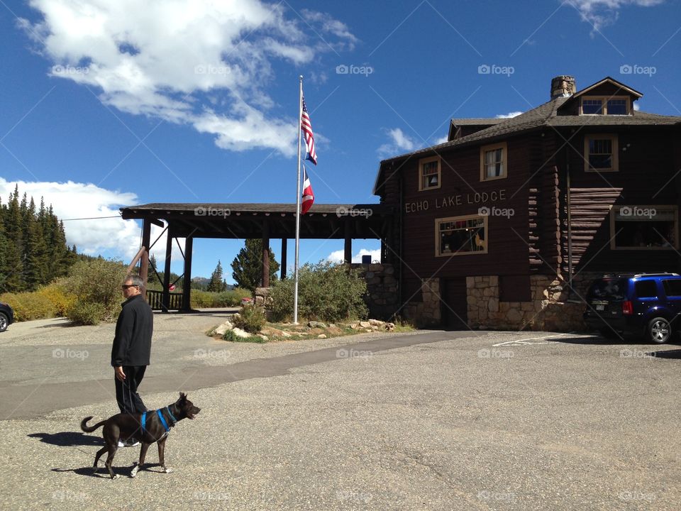 Man with dog near lodge cabin, Colorado