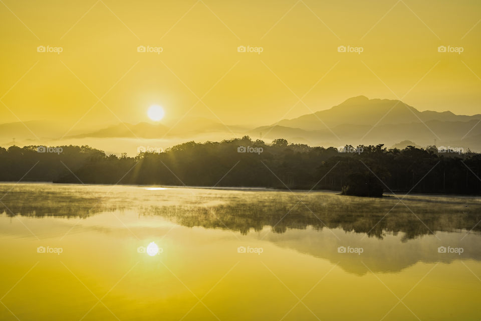 Beautiful sunrise and mountains reflection