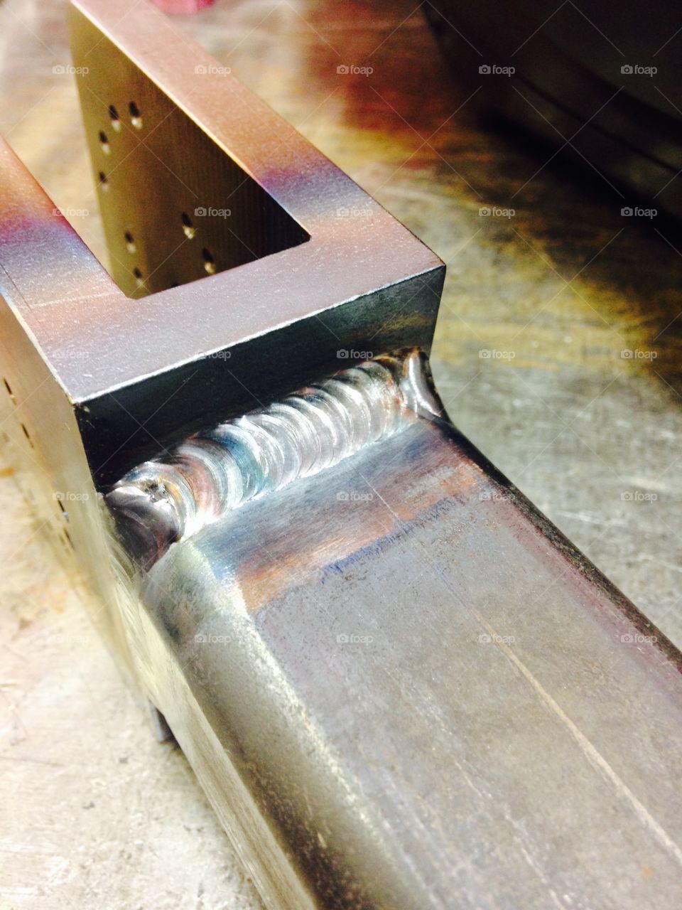 Welds together