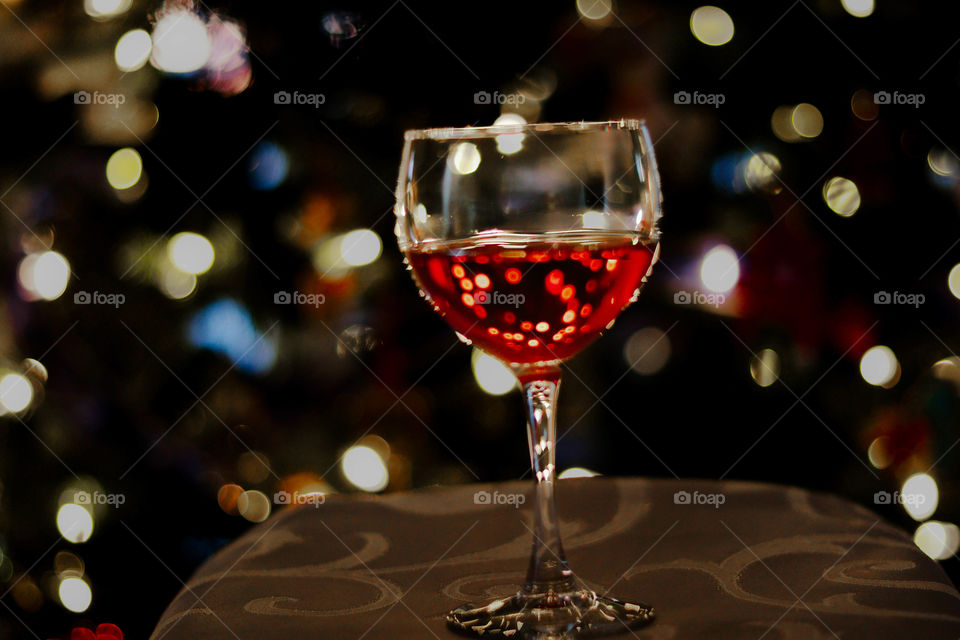 wine glass by Christmas lights