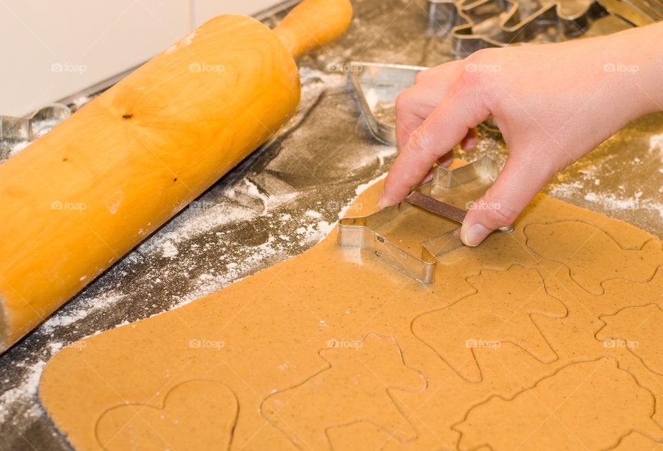 A person making gingerbread cookie