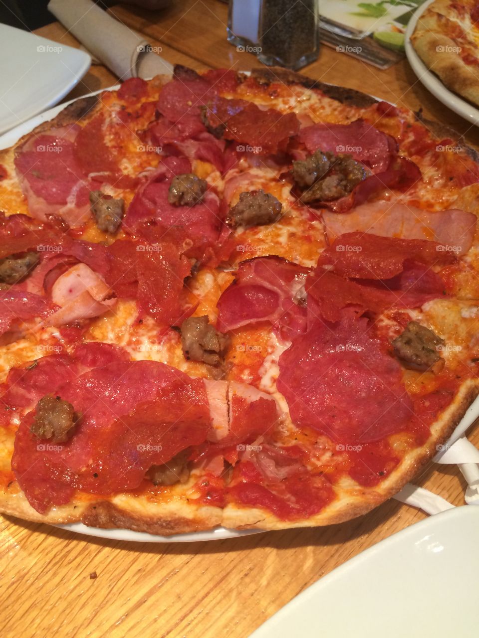 Pepperoni pizza. Tasty pepperoni pizza eating with family