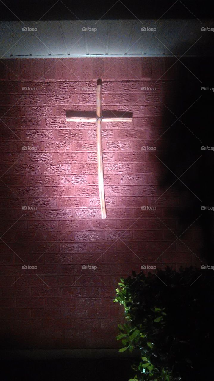 criss cross on the wall. My dad built this cross and hung it outside with the light